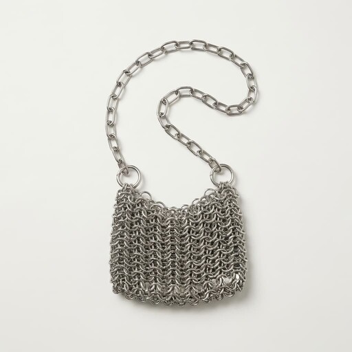 A stylish chainmail handbag featuring a delicate, interwoven metal link design and a sleek silver-color chain strap, elegantly displayed against a plain white background.