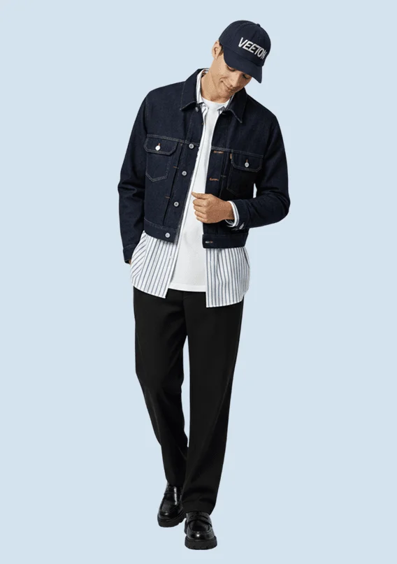 AI model in a Veeton cap, dark denim jacket, striped shirt and black trousers, generated with Veeton