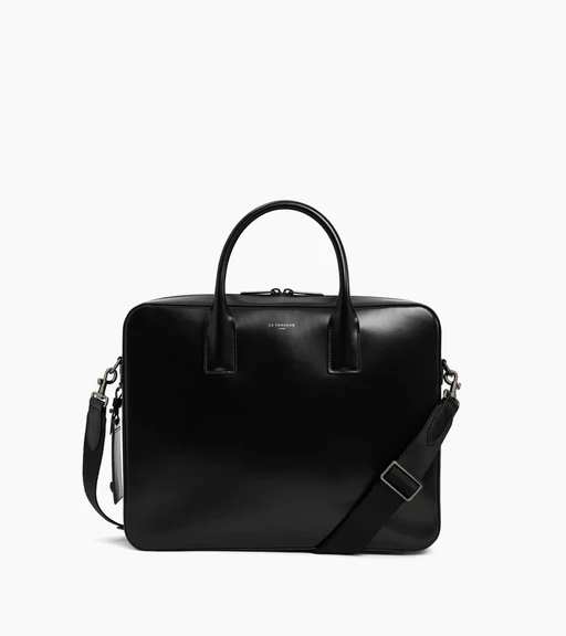 Packshot of a black leather briefcase with top handles and shoulder strap