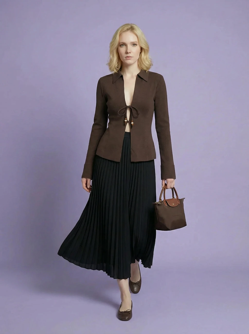 AI model in a brown tie-front cardigan and black pleated midi skirt on lilac, before editing with AI