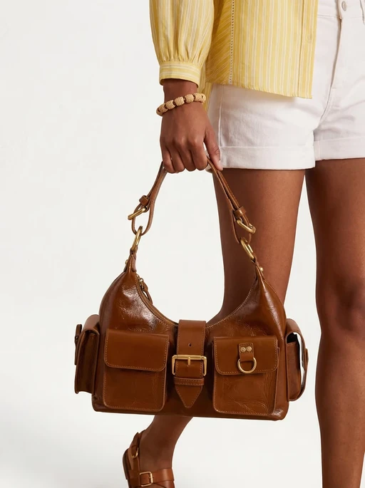 AI model in a yellow striped shirt and white shorts holding a tan leather shoulder bag, generated with Veeton