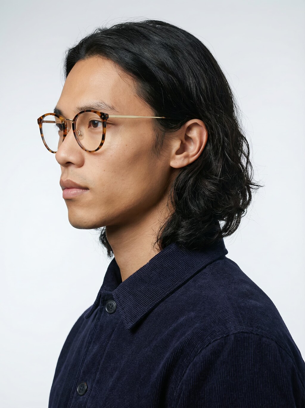 AI model in profile wearing round tortoiseshell glasses with gold temples, generated with Veeton