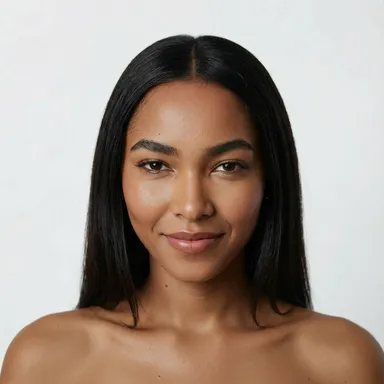A woman with long, straight black hair and smooth skin smiles softly against a plain white background.