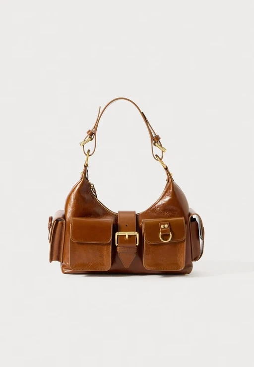 Packshot of a glossy tan leather shoulder bag with buckle and front pockets