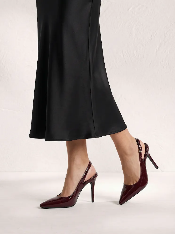 AI model in a black satin skirt wearing burgundy patent slingback heels, generated with Veeton