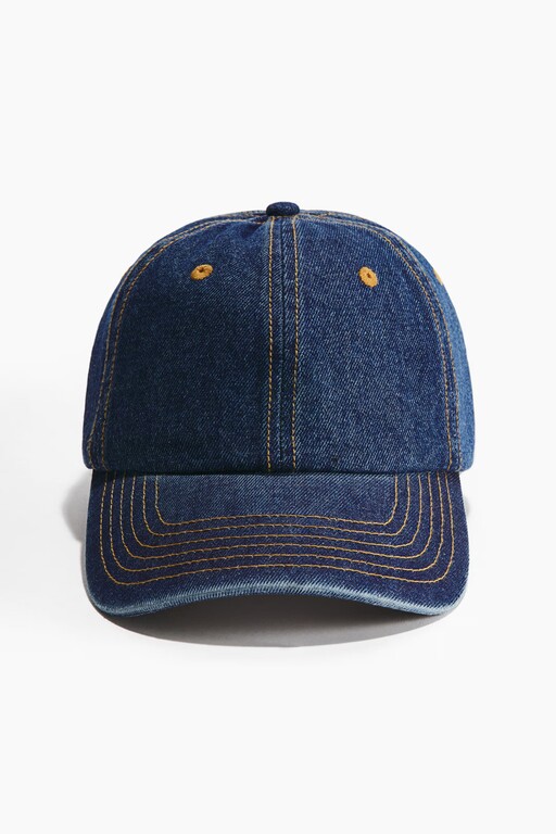 Packshot of a dark blue denim baseball cap with contrast stitching before on-model generation