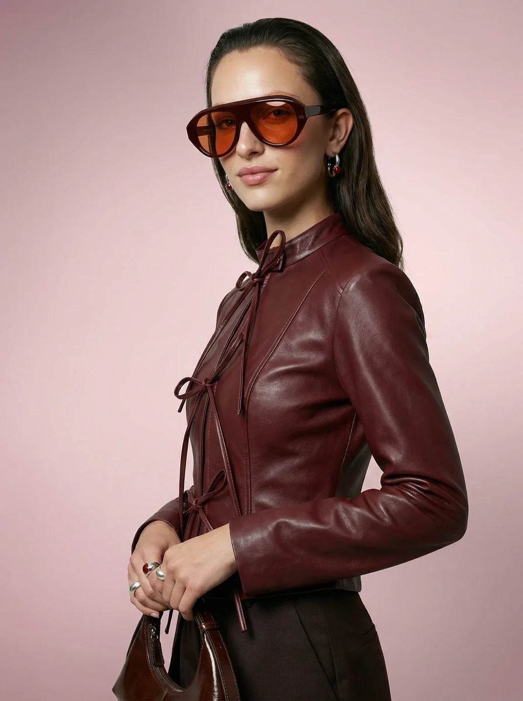 AI model in a burgundy leather jacket wearing burgundy aviator sunglasses with orange lenses, generated with Veeton
